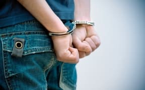 Youth in handcuffs