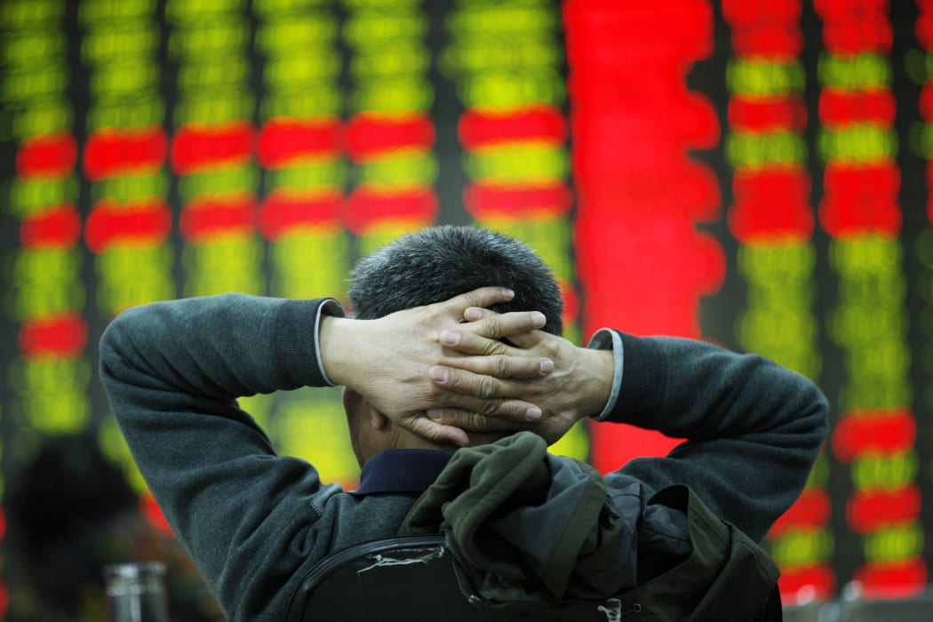 An investor watches an electric board in a stock market in Huaibei, Anhui, east China on 6 January 2016.