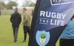 Logo of the Rugby For Life charity displayed at a rugby game.