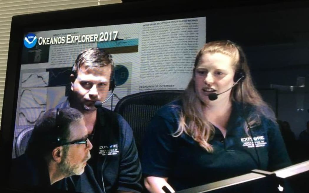 Del Bohnenstiehl (L) and Kasey Cantwell (R) talk to scientists in Wellington during a Pacific mission of the NOAA ship Okeanos Explorer