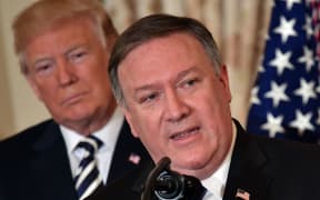 In this file photo taken on May 02, 2018, US President Donald Trump watches Mike Pompeo speak during his ceremonial swearing-in as US Secretary of State at the State Department in Washington, DC .