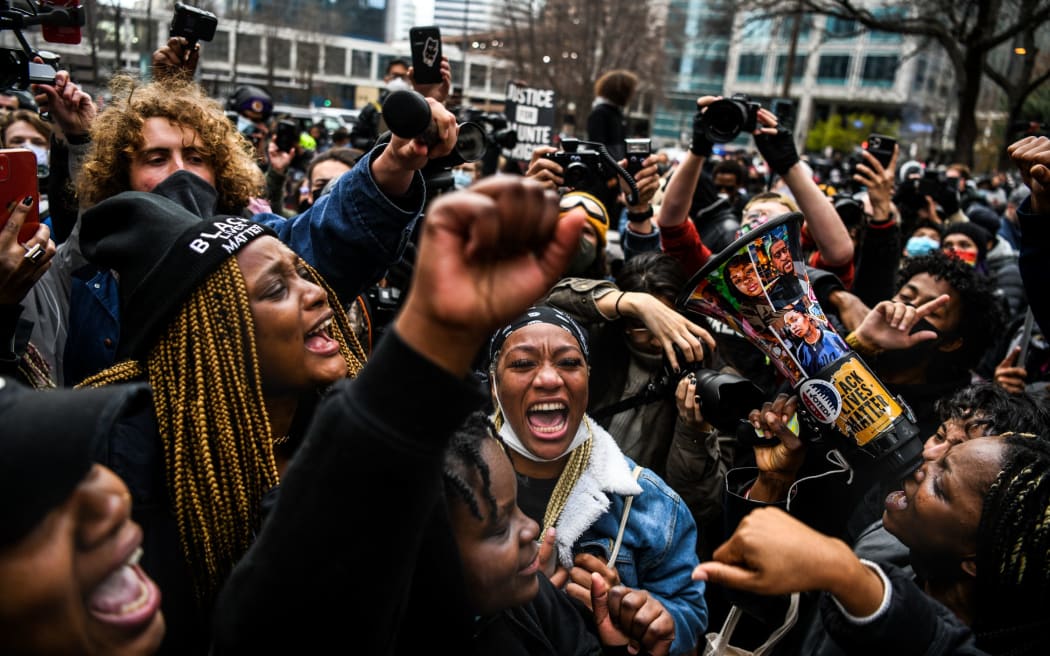 People celebrate as the verdict is announced in the trial of former police officer Derek Chauvin outside the Hennepin County Government Center in Minneapolis, Minnesota on April 20, 2021.