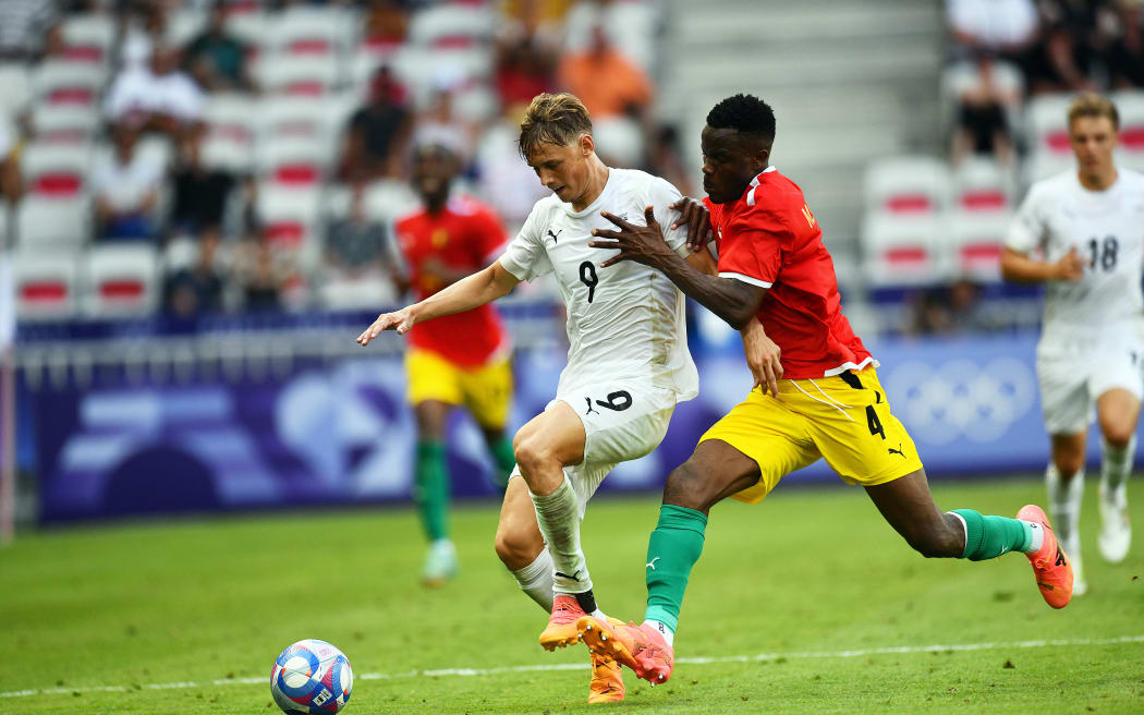 New Zealand's Ben Waine and Guinea's Mohamed Soumah contest possession in their Olympic men's football pool match.