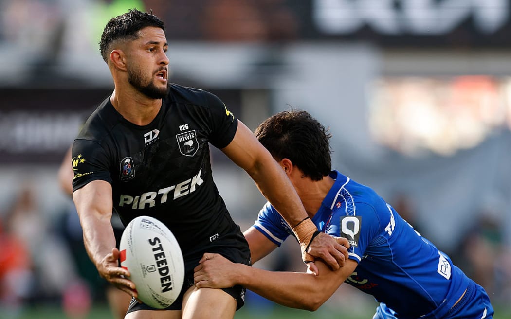 Dylan Brown of the Kiwis offloads the ball.