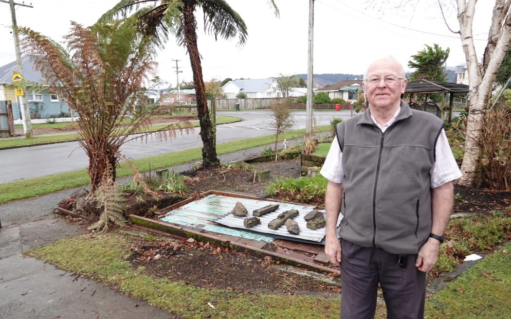 Nick Thorne stands in front of his former garden shed and vanished front fence.