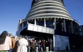 Marchers queue to enter Parliament with the rope of ribbons with survivors names on them.