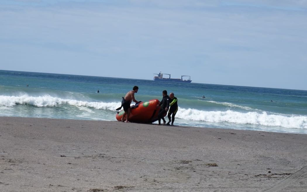 Surf Life Savers return to shore after searching for a five-year-old boy swept out to sea off Mount Maunganui.