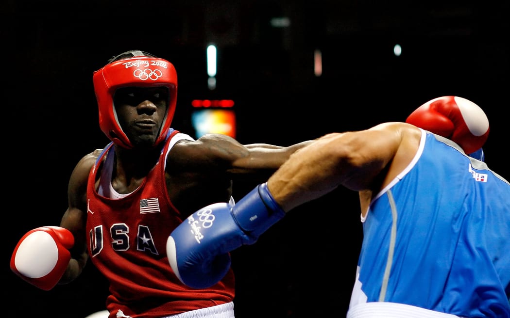 Clemente Russo of Italy (blue) fights Deontay Wilder of the United States (red).