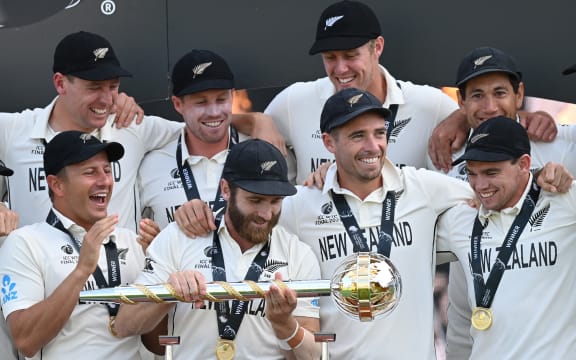 New Zealand's captain Kane Williamson (C) holds the winner's Mace as New Zealand players celebrate victory on the final day of the ICC World Test Championship Final between New Zealand and India at the Ageas Bowl in Southampton, southwest England on June 23, 2021.