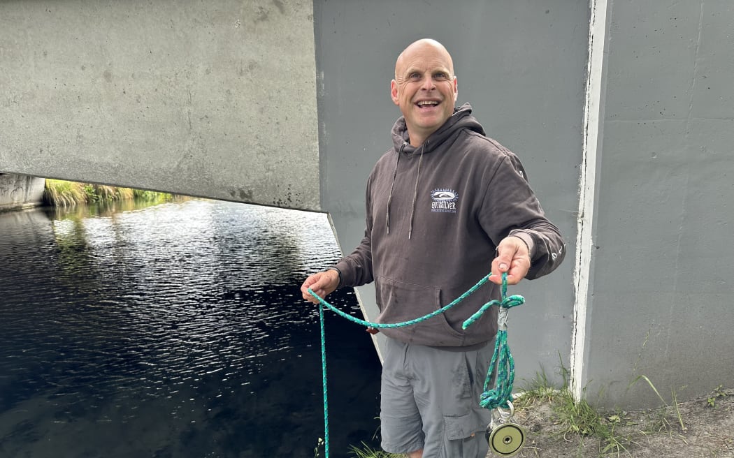 Tim Riley magnet fishing at the Avon River, Christchurch.