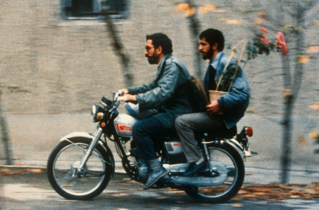After his sentence, Sabzian is picked up by the real Makhmalbaf on his motorbike so he can visit the Ahankah family and apologise.