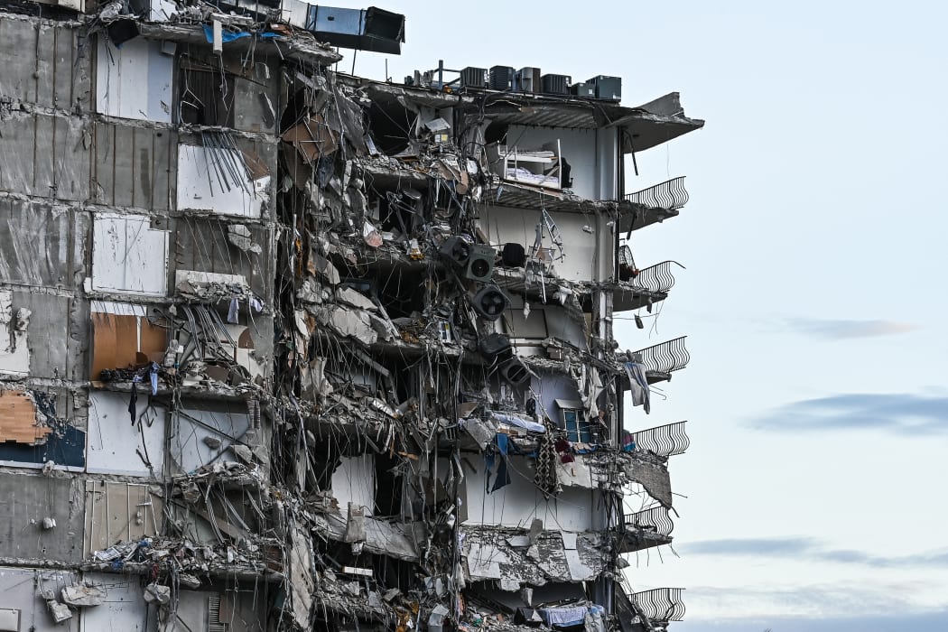 Rubble hangs from a partially collapsed building in Surfside north of Miami Beach