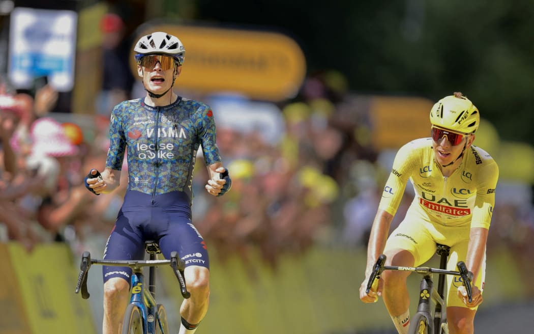 Danish rider Jonas Vingegaard (L) cycles to the finish line to win stage 11 of the Tour de France ahead of Slovenian rider Tadej Pogacar.