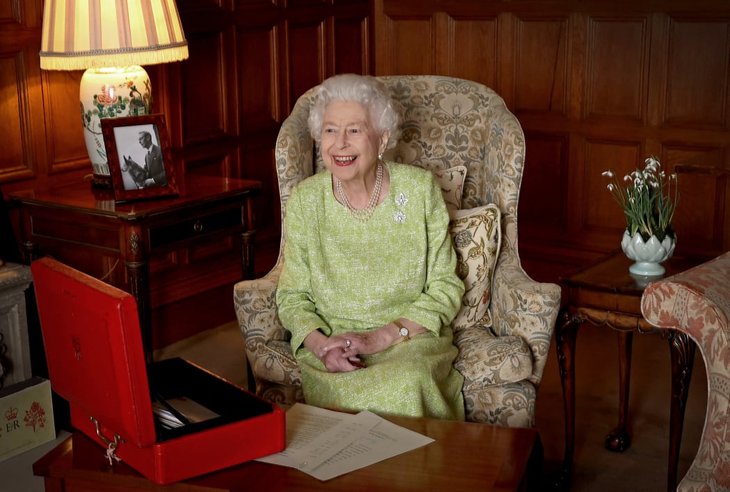 A Buckingham Palace handout image released on 6 February shows Britain's Queen Elizabeth II smiling as she sits in Sandringham House in Norfolk, eastern England on February 2, 2022, released to mark the start of Her Majesty's Platinum Jubilee Year.