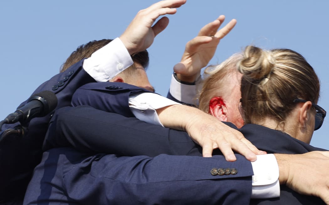 Republican presidential candidate former President Donald Trump is rushed offstage during a rally on 13 July, 2024 in Butler, Pennsylvania.