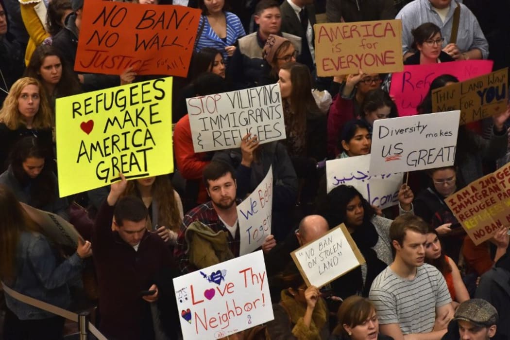Protesters rally against Trump's seven-country ban at Reagan National Airport in Arlington, Virginia