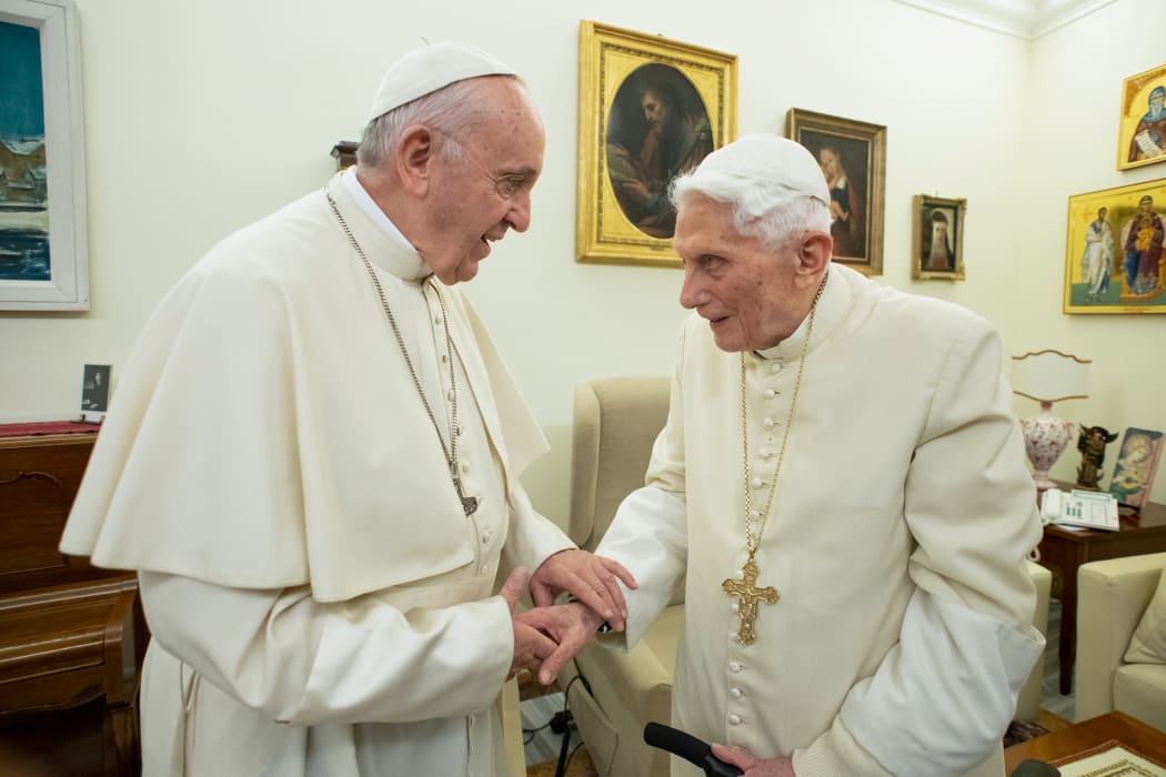 (FILES) This file handout picture taken and released by Vatican Media on December 21, 2018, shows Pope Francis (L) meeting with Pope Benedict XVI (R) at the Vatican.