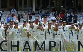 Australia's Pat Cummins lifts the ICC Test Championship Mace as he celebrates with teammates after victory in the ICC World Test Championship cricket final against India at The Oval, 2023.