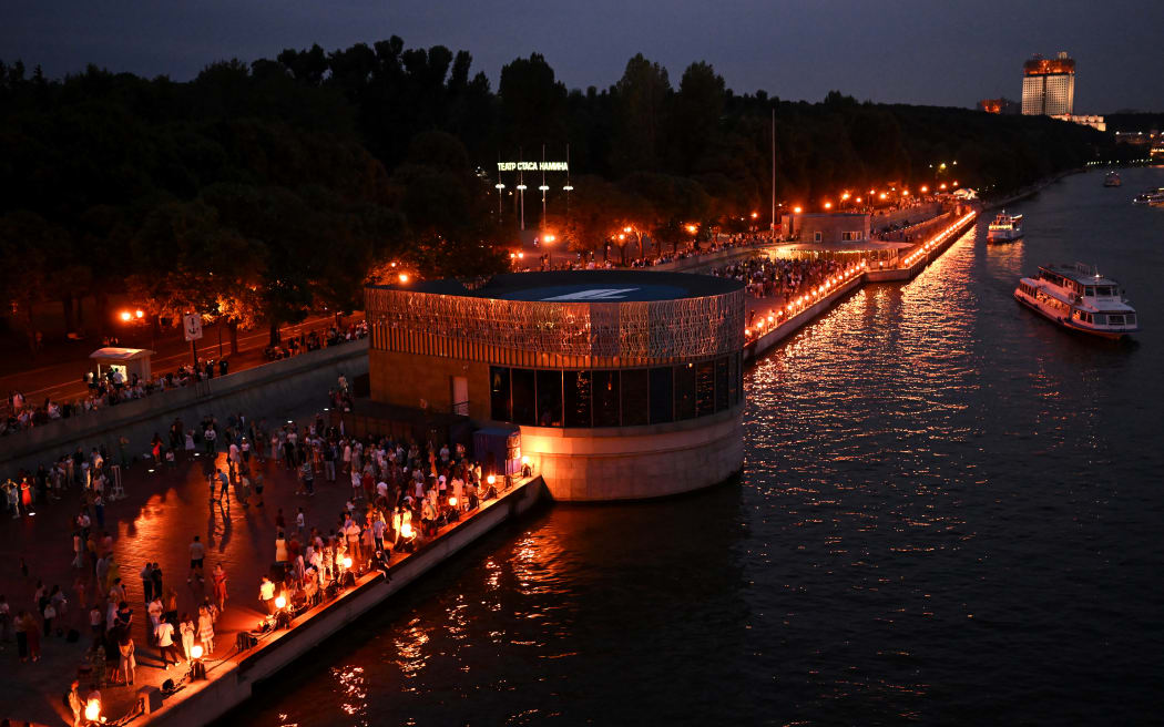 People enjoy the sunny evening dancing on the embankment of the Moskva River in central Moscow, on August 19, 2023.