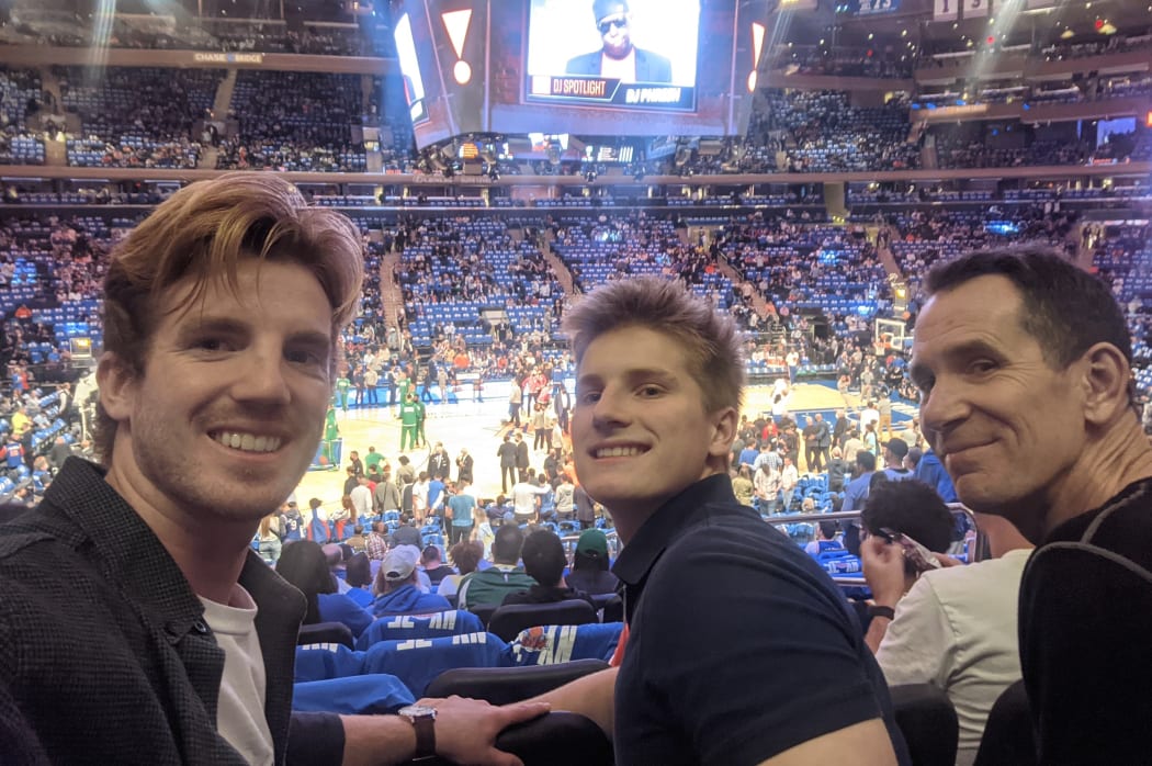Kevin Coldiron (far right) and his sons Jackson (left) and Cy at a basketball game in New York.