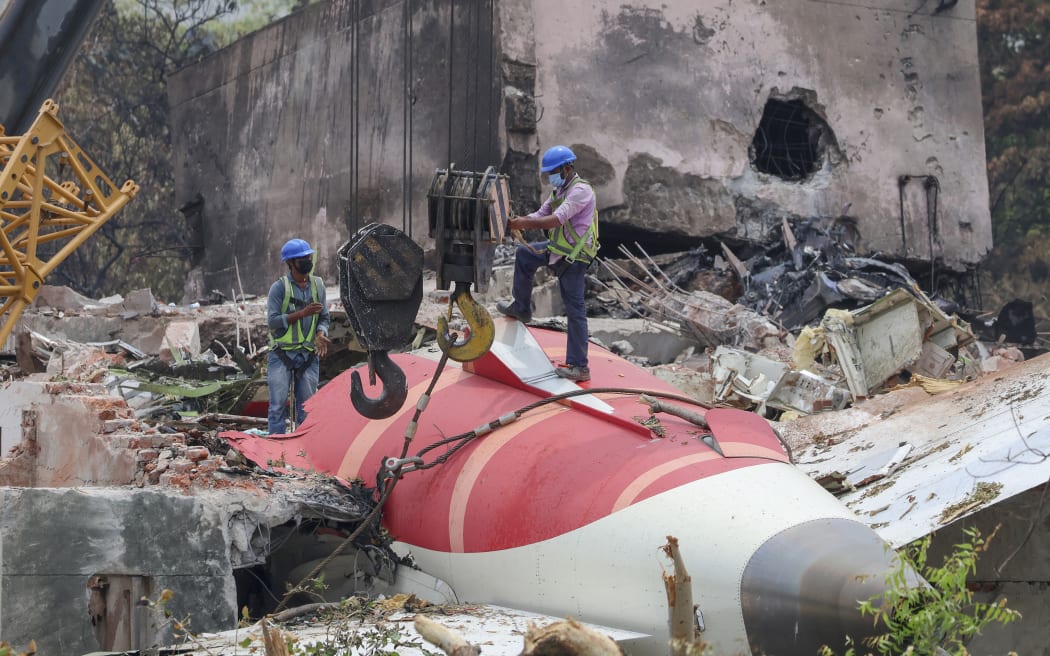 Members of Indian Army's engineering arm prepare to remove the wreckage of an Air India aircraft, bound for London's Gatwick Airport, which crashed during take-off from an airport in Ahmedabad, India June 14, 2025. (Photo by Basit Zargar / Middle East Images via AFP)