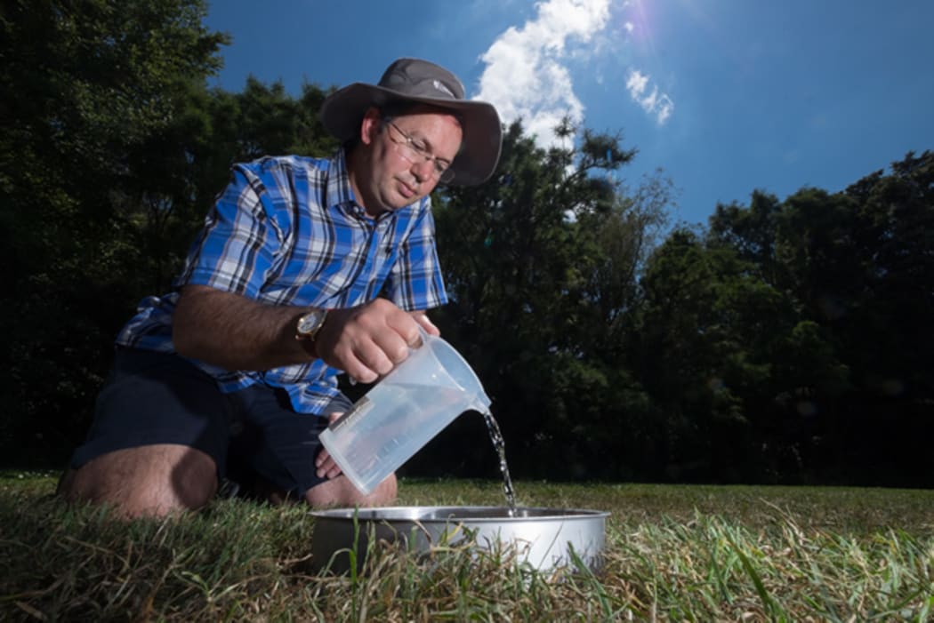 Sam Carrick testing water inflitration into soil