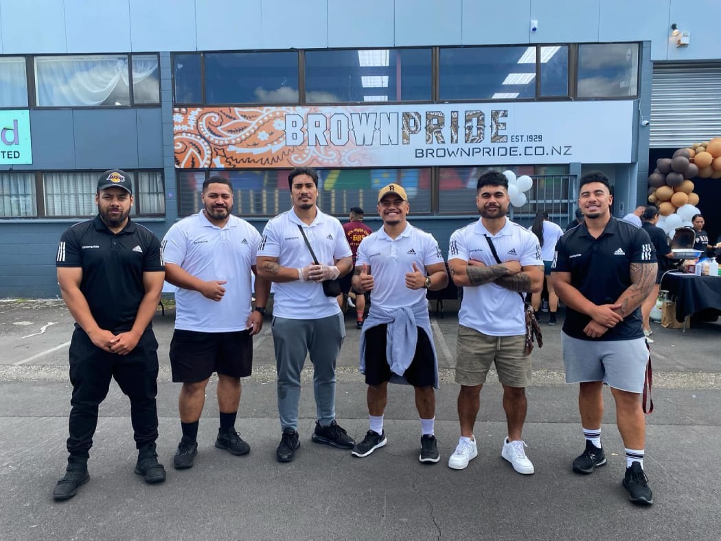 The six men who founded Brown Pride at the opening of their gym, including Johnnie Timu (third from right).