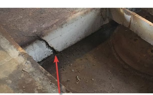 Structural cracks on a cross-member in the skid plate / king pin assembly of a refrigerated trailer (found after the flooring was removed to reveal an internal chamber).