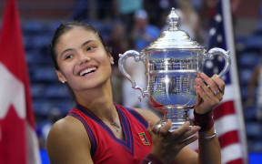 Britain's Emma Raducanu celebrates with the trophy after winning the 2021 US Open Tennis tournament women's final match against Canada's Leylah Fernandez at the USTA Billie Jean King National Tennis Center in New York, on September 11, 2021.