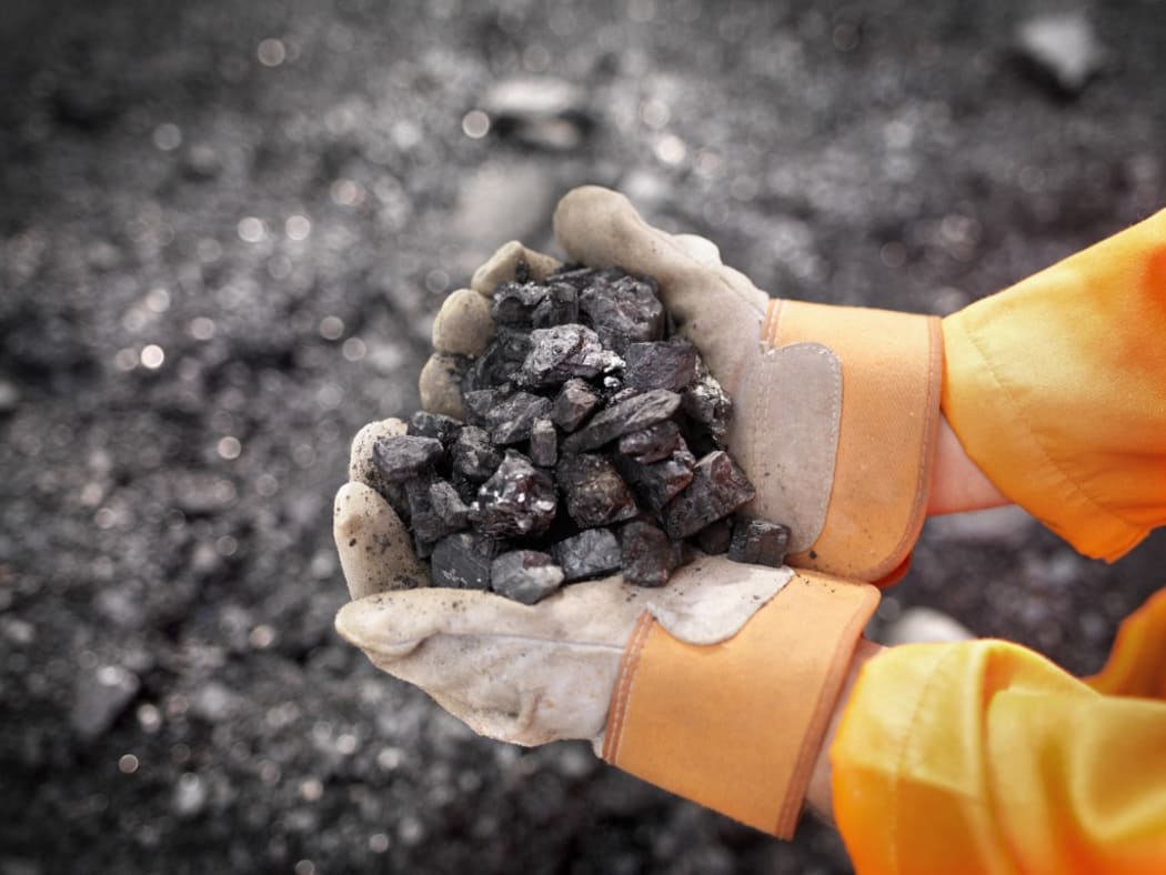 Coal Worker With Handful Of Coal (Photo by Monty Rakusen / Cultura Creative / Cultura Creative via AFP)