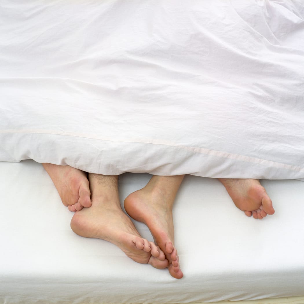 Bare feet of couple in bed (Photo by STOCK4B GMBH / Image Source / Image Source via AFP)