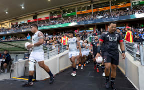 Moana Pasifika captain Michael Alaalatoa and Māori All Blacks captain Ash Dixon lead their team out to the field before the rugby match at FMG Stadium, Hamilton, New Zealand.