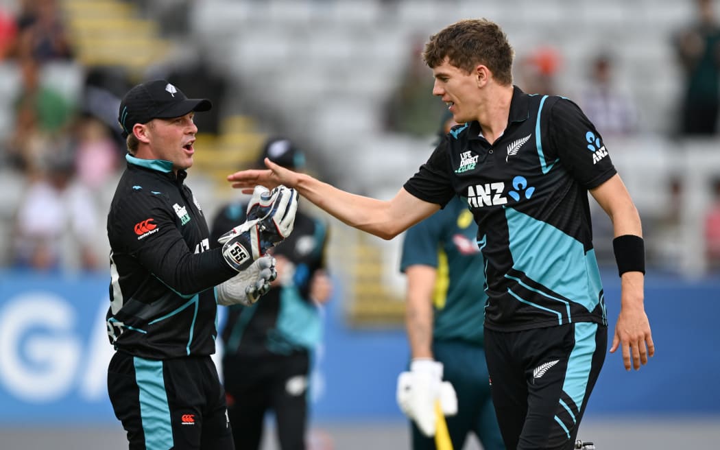 New Zealand wicketkeeper Tim Seifert and bowler Ben Sears celebrate the wicket of Matthew Short.