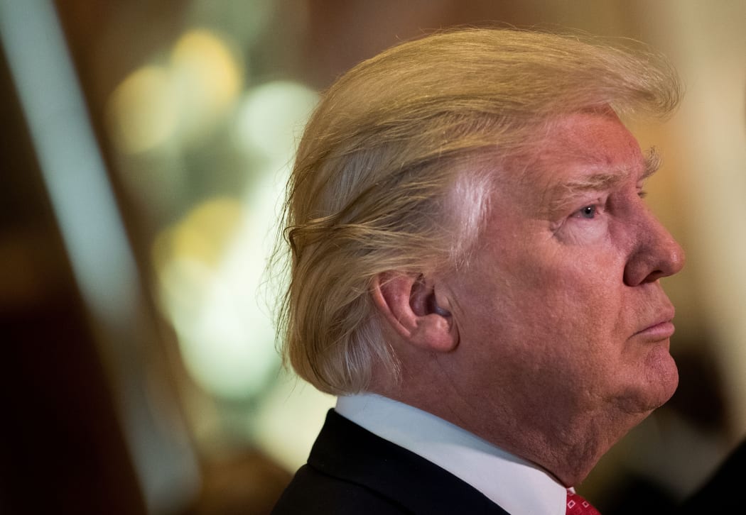 President-elect Donald Trump speaks to reporters in the lobby after meeting with French businessman Bernard Arnault, chief executive officer of LVMH, at Trump Tower, January 9, 2017.