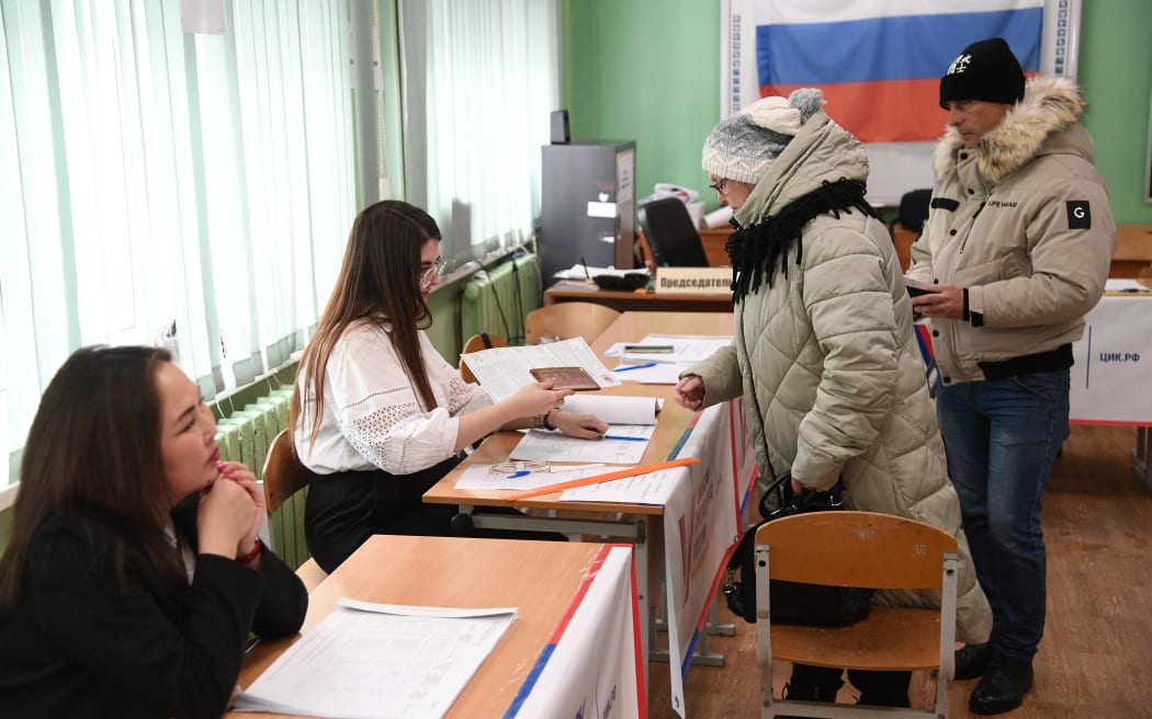 People register to vote in Russia's presidential election in the city of Yuzhno-Sakhalinsk on far eastern Sakhalin Island on 17 March, 2024.