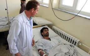 A wounded Afghan receives treatment at a hospital in Kunduz province on August 9, 2015, after a Taliban attack in the northern Afghan city. The Taliban claimed responsibility for the attack. AFP PHOTO/Nasir Waqif