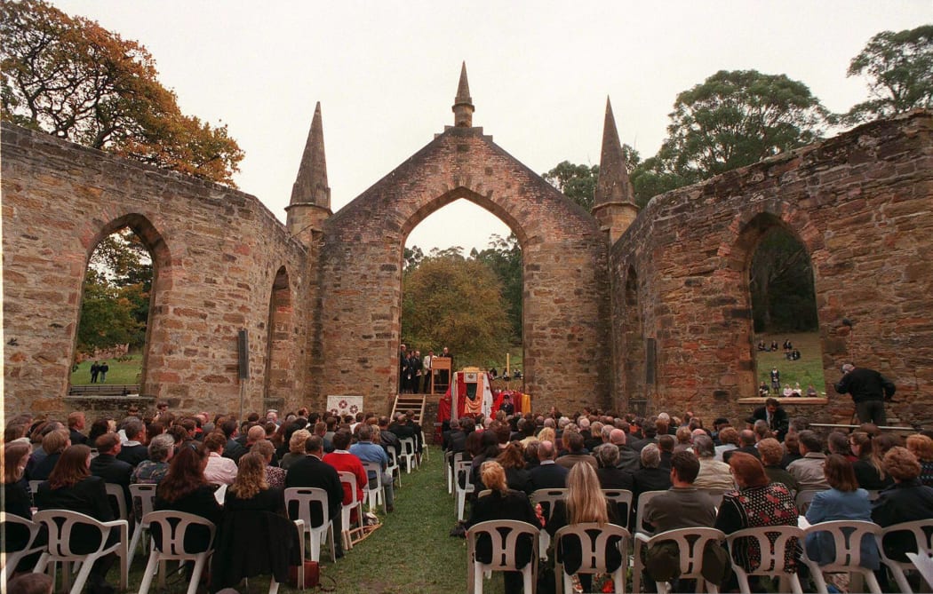 Relatives of victims killed or wounded by gunman Martin Bryant attend a memorial service in the ruins of Port Arthur 28 April to commemorate the first anniversary of the massacre.
