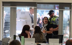 A protester is removed from the Kaipara District Council meeting. Credit: Michael Craig /NZM (LDR single use only)