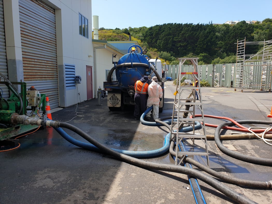 Sludge being pumped into trucks.