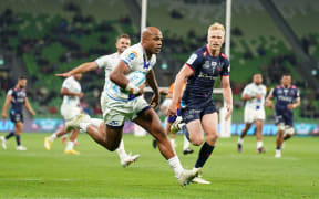 Mark Tele'a of the Blues scores a try during the Super Rugby Pacific Round 11 match between the Melbourne Rebels and the Blues in Melbourne, 2024.