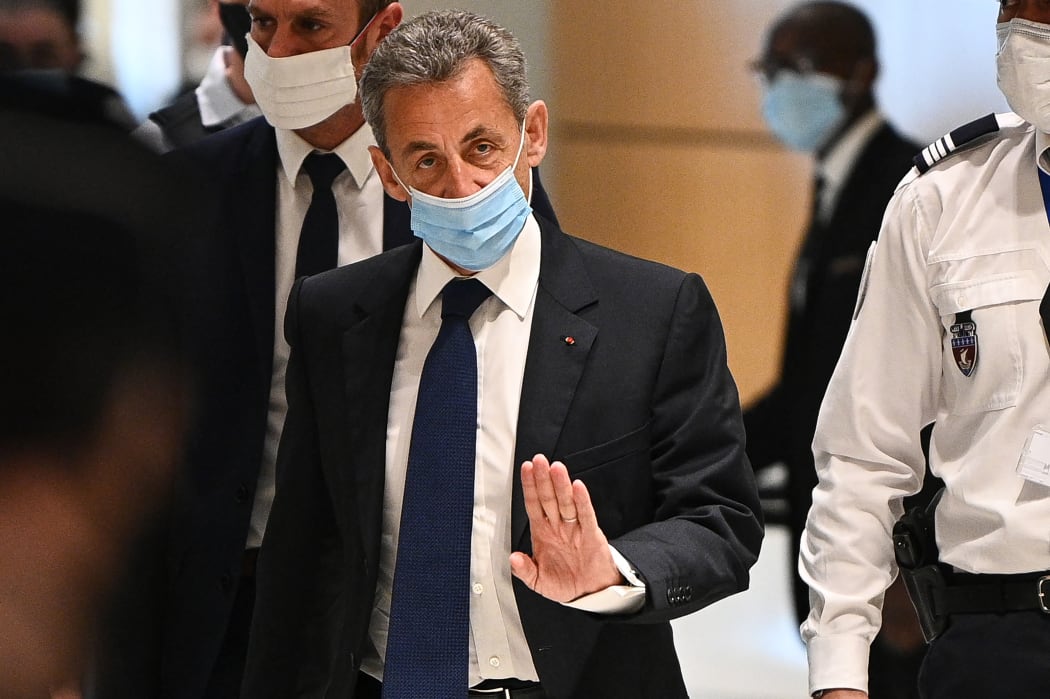 Former French president Nicolas Sarkozy arrives at a Paris courthouse to hear the final verdict in a corruption trial on 1 March 2021.