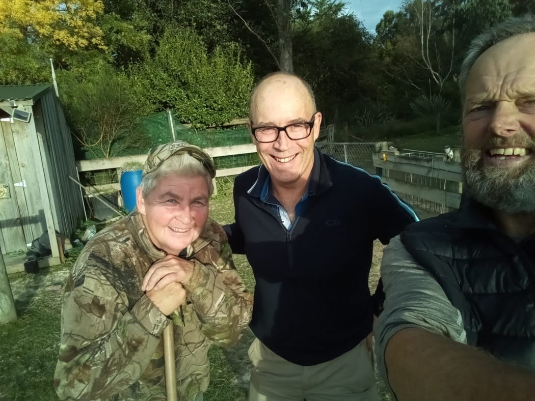 Reaching the Topp - well, one of them. Lynda with Paul and Bruce ready to do the chores