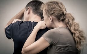 Sad woman hugging her husband