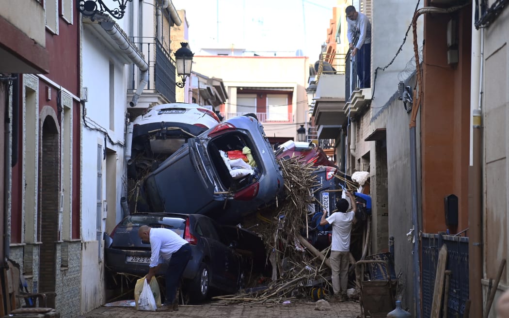 Debris stuff a street, on November 1, 2024, after a flooding devastated the town of Paiporta, in the region of Valencia, eastern Spain. - The death toll from Spain's worst floods in a generation has climbed to 205, rescuers said today, with the number expected to rise as more people are believed missing. The agency coordinating emergency services in the eastern Valencia region said 202 people had been confirmed dead there, with officials in Castilla-La Mancha and Andalusia previously announcing a combined three deaths in their regions. (Photo by JOSE JORDAN / AFP)