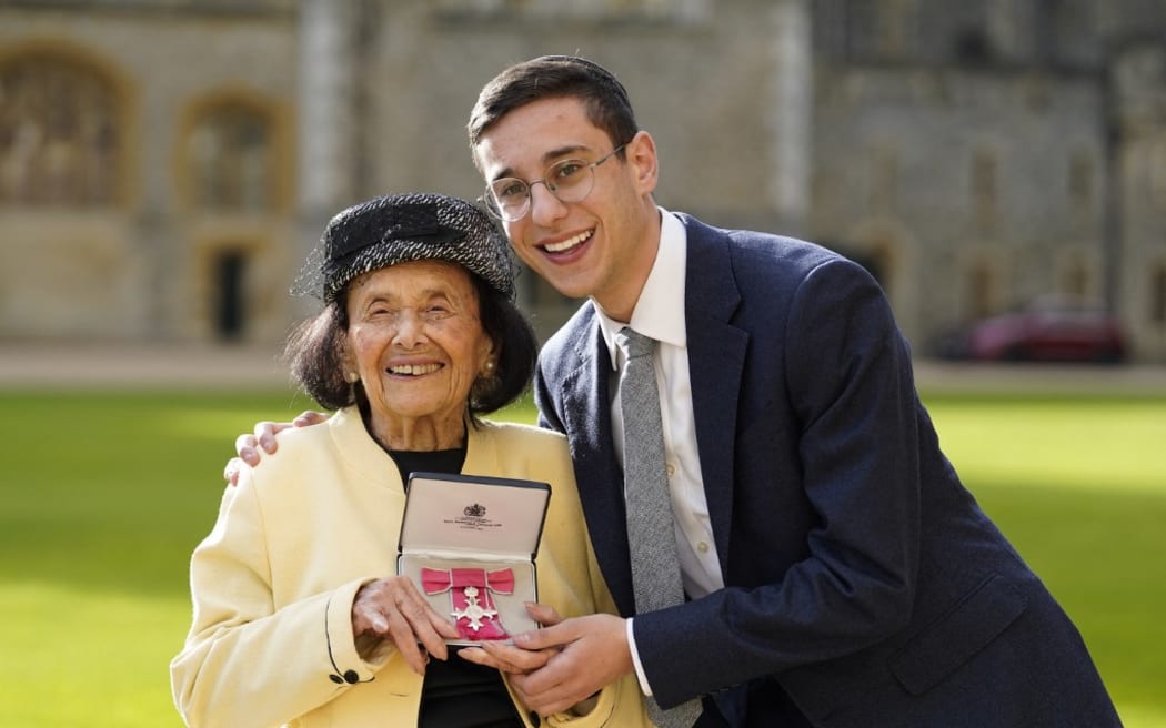 Hungarian-born Holocaust survivor Lily Ebert (L) stands with her her great-grandson Dov Forman as she poses with her medal after being appointed a Member of the Order of the British Empire (MBE) following an investiture ceremony at Windsor Castle, on January 31, 2023.