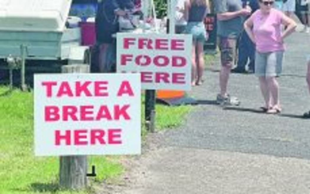 A "fatigue stop" set up with a tent and signs beside the road, encouraging people to "take a break".