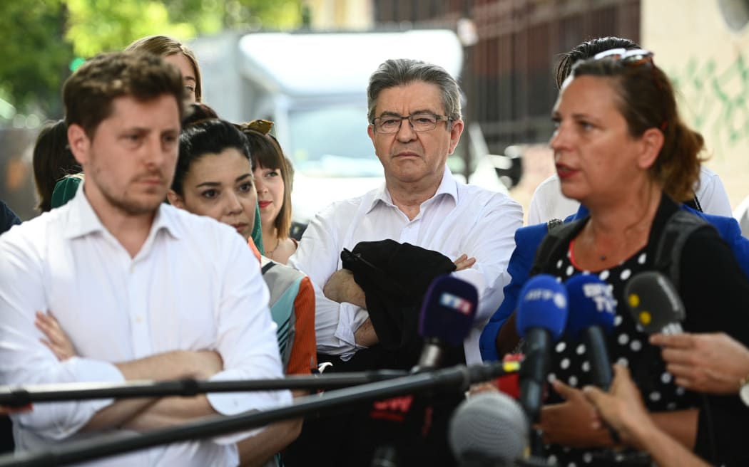 Jean-Luc Melenchon, centre, listens to Paris mayor deputy Lea Filoche, right, flanked by Nupes candidate and Europe Ecologie Les Verts (EELV) party general secretary Julien Bayou.