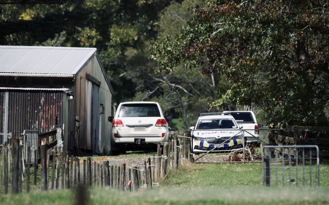 Police cars at a property on Anzac Valley Rd in rural Waitākere, west Auckland, on 18 April 2024.