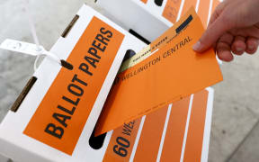 WELLINGTON, NEW ZEALAND - OCTOBER 17: A person casts their vote at a polling station during election day on October 17, 2020 in Wellington, New Zealand. Voters head to the polls today to elect the 53rd Parliament of New Zealand. The 2020 New Zealand General Election was originally due to be held on Saturday 19 September but was delayed due to the re-emergence of COVID-19 in the community. (Photo by Hagen Hopkins/Getty Images)