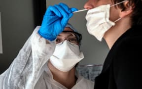 A person has a sample collected to be tested for COVID-19 on March 23, 2020, at the CBM69 laboratory, part of Eurofins clinical diagnostics group, in Villeurbanne, central-eastern France,